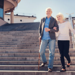 senior couple walking down stairs
