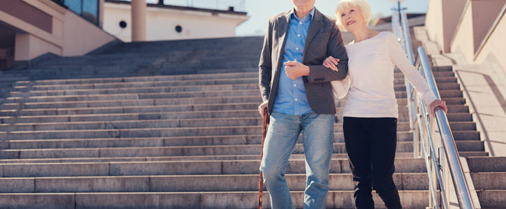 senior couple walking down stairs