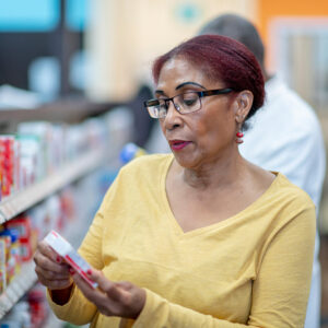 Image of woman in product isle of store.