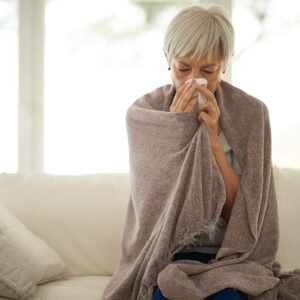Image of person with cold, blowing nose